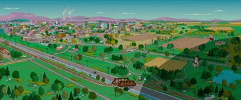Movie still from “The Simpsons Movie” (2007), directed by David Silverman – An animated city with a train coming down the tracks; Extreme Wide shot, High angle
