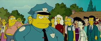 Movie still from “The Simpsons Movie” (2007), directed by David Silverman – A group of people standing in a line with a man dressed as a police officer; Medium shot, Low angle