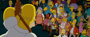 Movie still from “The Simpsons Movie” (2007), directed by David Silverman – A group of people standing around each other in a room; Medium shot, Over the shoulder angle