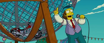 Movie still from “The Simpsons Movie” (2007), directed by David Silverman – A man standing next to a wooden structure; Medium shot, Low angle