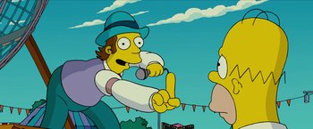 Movie still from “The Simpsons Movie” (2007), directed by David Silverman – A man with a microphone in his hand is singing to a crowd; Medium shot, Over the shoulder angle