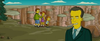 Movie still from “The Simpsons Movie” (2007), directed by David Silverman – A family is standing in front of a rock wall; Wide shot, High angle