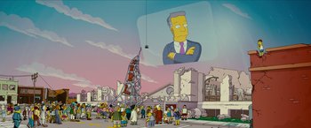 Movie still from “The Simpsons Movie” (2007), directed by David Silverman – A crowd of people standing in front of a building with an image on it; Extreme Wide shot, Low angle