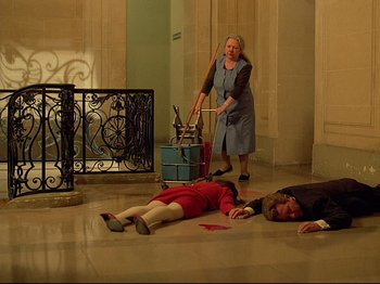 Movie still from “First Name: Carmen” (1983), directed by Jean-Luc Godard – A woman and a boy are laying on the floor; Wide shot, High angle