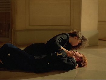 Movie still from “First Name: Carmen” (1983), directed by Jean-Luc Godard – A man and a woman laying on the ground; Wide shot, High angle