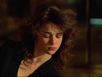 Movie still from “First Name: Carmen” (1983), directed by Jean-Luc Godard – A person wearing a black shirt; Close Up shot, Low angle