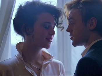 Movie still from “First Name: Carmen” (1983), directed by Jean-Luc Godard – A man and a woman face to face in front of a window; Close Up shot, Low angle