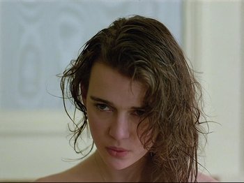 Movie still from “First Name: Carmen” (1983), directed by Jean-Luc Godard – A person with long brown hair; Close Up shot, Low angle