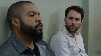 Two men sitting next to each other in a room