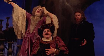 Movie still from “Fitzcarraldo” (1982), directed by Werner Herzog – A man sitting on top of another man's head; Medium shot, Low angle