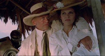 Movie still from “Fitzcarraldo” (1982), directed by Werner Herzog – An older man and a younger woman wearing hats; Close Up shot, Low angle