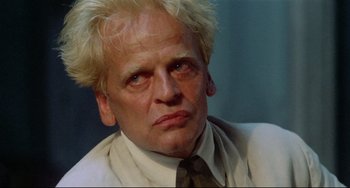 Movie still from “Fitzcarraldo” (1982), directed by Werner Herzog – A person wearing a suit and tie; Close Up shot, Low angle