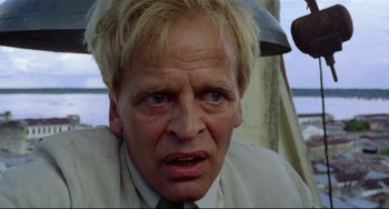 Movie still from “Fitzcarraldo” (1982), directed by Werner Herzog – A person wearing a suit and tie; Close Up shot, Low angle