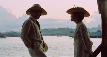 Movie still from “Fitzcarraldo” (1982), directed by Werner Herzog – A man and a woman standing next to a body of water; Medium shot, Over the shoulder angle