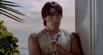 Movie still from “Fitzcarraldo” (1982), directed by Werner Herzog – A man holding a wine glass in his right hand; Medium shot, Low angle