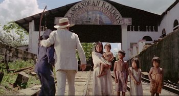 Movie still from “Fitzcarraldo” (1982), directed by Werner Herzog – A group of people standing on a train track; Wide shot, Low angle