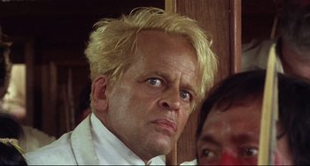 Movie still from “Fitzcarraldo” (1982), directed by Werner Herzog – A person with blonde hair; Close Up shot, Low angle