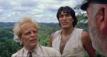 Movie still from “Fitzcarraldo” (1982), directed by Werner Herzog – Two men standing next to each other on top of a hill; Medium shot, Low angle