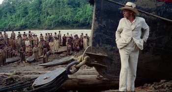 Movie still from “Fitzcarraldo” (1982), directed by Werner Herzog – A group of people standing on top of a boat; Wide shot, Low angle