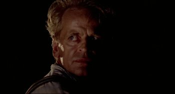 Movie still from “Fitzcarraldo” (1982), directed by Werner Herzog – A person in a dark room; Close Up shot, Low angle