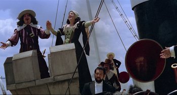 Movie still from “Fitzcarraldo” (1982), directed by Werner Herzog – A group of people dressed in medieval clothing on top of a boat; Wide shot, Low angle