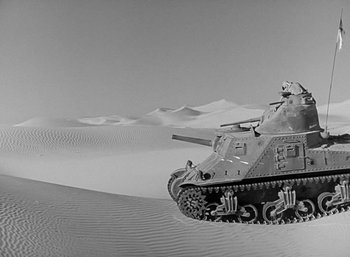 Movie still from “Five Graves to Cairo” (1943), directed by Billy Wilder – An old tank is in the middle of the desert; Extreme Wide shot, High angle
