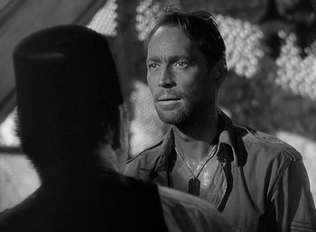 Movie still from “Five Graves to Cairo” (1943), directed by Billy Wilder – Black and white photograph of a man and a woman; Close Up shot, Over the shoulder angle