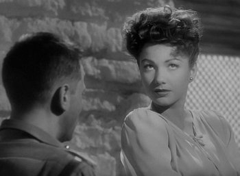 Movie still from “Five Graves to Cairo” (1943), directed by Billy Wilder – An old photo of a man and a woman; Close Up shot, Over the shoulder angle