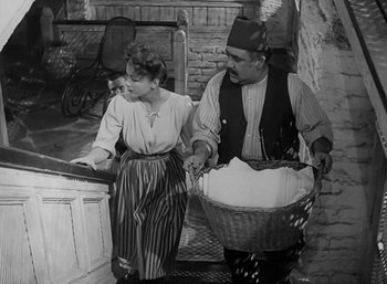 Movie still from “Five Graves to Cairo” (1943), directed by Billy Wilder – An old black and white photo of a man and a woman; Medium shot, High angle