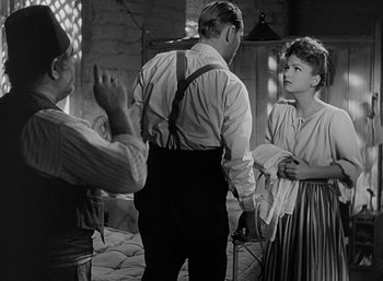 Movie still from “Five Graves to Cairo” (1943), directed by Billy Wilder – An old black and white photo of a man and a woman; Medium shot, Over the shoulder angle