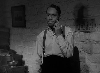 Movie still from “Five Graves to Cairo” (1943), directed by Billy Wilder – A black and white photo of a man talking on a cell phone; Close Up shot, Low angle