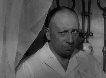 Movie still from “Five Graves to Cairo” (1943), directed by Billy Wilder – An older man in a white shirt is looking at the camera; Close Up shot, Low angle