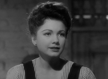 Movie still from “Five Graves to Cairo” (1943), directed by Billy Wilder – A black - and - white photo of a woman in a striped shirt; Close Up shot, High angle