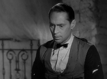 Movie still from “Five Graves to Cairo” (1943), directed by Billy Wilder – An old photo of a man in a black and white photo; Close Up shot, Over the shoulder angle