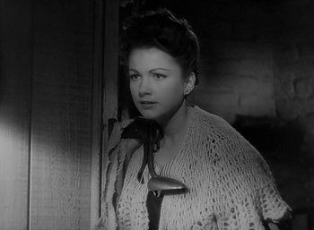 Movie still from “Five Graves to Cairo” (1943), directed by Billy Wilder – A black - and - white photo of a woman in a sweater; Close Up shot, High angle