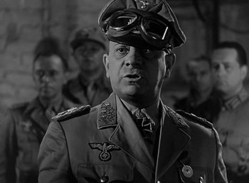 Movie still from “Five Graves to Cairo” (1943), directed by Billy Wilder – A man in a military uniform and a hat; Close Up shot, Low angle