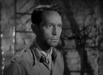 Movie still from “Five Graves to Cairo” (1943), directed by Billy Wilder – A man in a military uniform is looking at the camera; Close Up shot, High angle