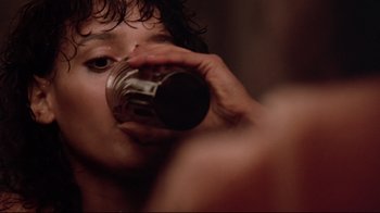 Movie still from “Flashdance” (1983), directed by Adrian Lyne – A man drinking from a metal cup; Close Up shot, Low angle