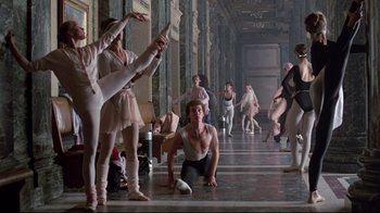 Movie still from “Flashdance” (1983), directed by Adrian Lyne – A group of people standing in a room; Wide shot, Low angle