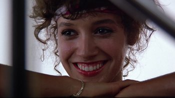 Movie still from “Flashdance” (1983), directed by Adrian Lyne – A woman's face with her hand on her head; Close Up shot, Low angle