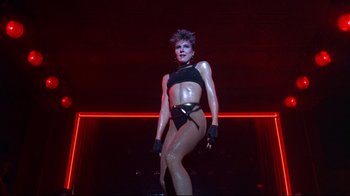 Movie still from “Flashdance” (1983), directed by Adrian Lyne – A woman in a black and white body suit; Medium shot, Low angle