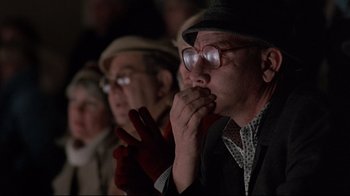 Movie still from “Flashdance” (1983), directed by Adrian Lyne – An older man wearing glasses and a hat is watching a performance; Close Up shot, Low angle