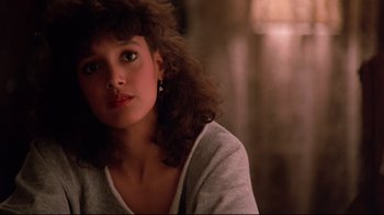 Movie still from “Flashdance” (1983), directed by Adrian Lyne – A young woman sitting in front of a window; Close Up shot, Over the shoulder angle
