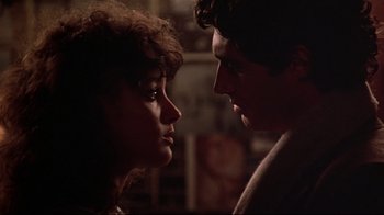 Movie still from “Flashdance” (1983), directed by Adrian Lyne – A man and a woman looking at each other; Close Up shot, Over the shoulder angle