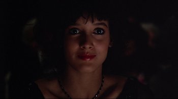 Movie still from “Flashdance” (1983), directed by Adrian Lyne – A young woman with dark hair and blue eyes looking up; Close Up shot, Low angle