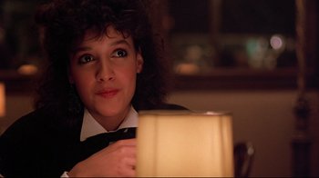 Movie still from “Flashdance” (1983), directed by Adrian Lyne – A woman is holding a candle in her hand; Close Up shot, Low angle