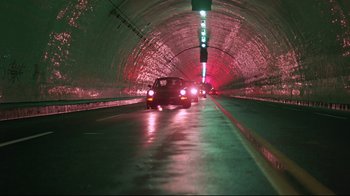 Movie still from “Flashdance” (1983), directed by Adrian Lyne – A car driving down a street in a tunnel; Extreme Wide shot, High angle