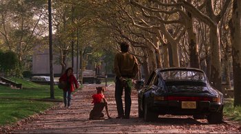 Movie still from “Flashdance” (1983), directed by Adrian Lyne – A man and a dog on the side of the road; Wide shot, Over the shoulder angle