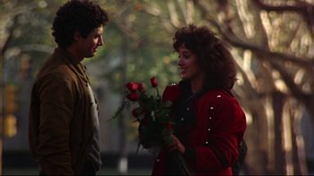 Movie still from “Flashdance” (1983), directed by Adrian Lyne – A man and a woman holding a bouquet of roses; Medium shot, Over the shoulder angle