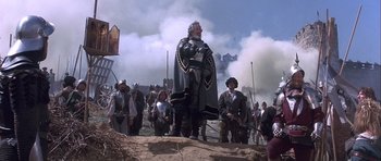 Movie still from “Flesh+Blood” (1985), directed by Paul Verhoeven – A group of people dressed in medieval costumes; Wide shot, Low angle